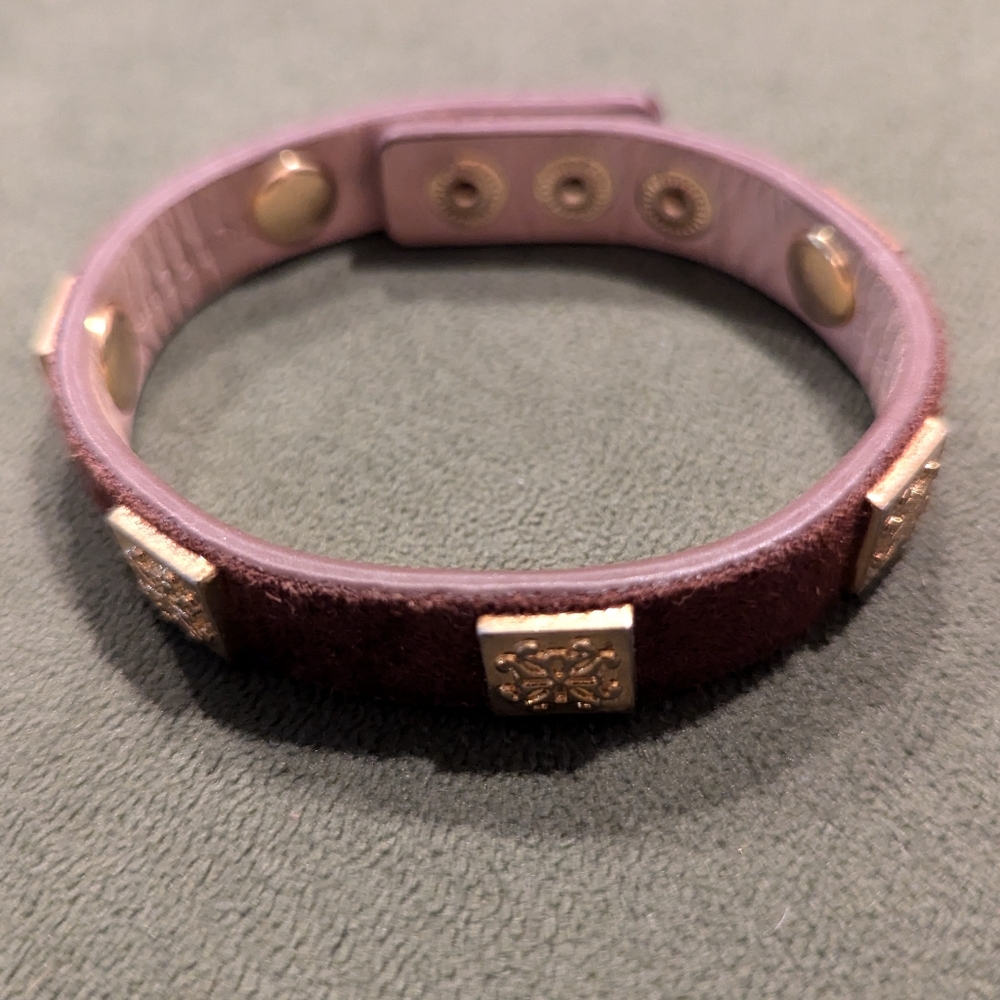 Rustic Cuff, red leather with logoed gold plates and a button clasp